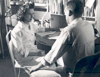 Medical social work student interviewing patient, ca. 1950