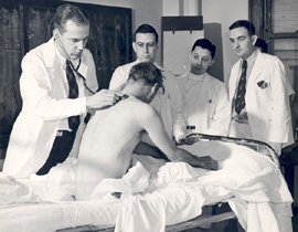 Dr. W. Barry Wood, examining patient, ca 1947
